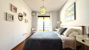 a small bedroom with a bed and a window at 525 Aguamarina in San Miguel de Abona +8 photos