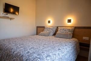 a bedroom with a large bed with two pillows at Petit balcon du lac in Lathuile