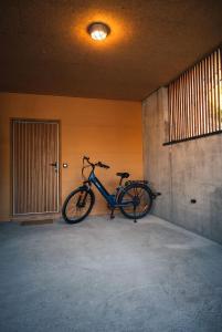 a bike parked against a wall in a room at Petit balcon du lac in Lathuile