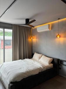 a bedroom with a bed and a ceiling fan at Crown Chaloklum in Chaloklum
