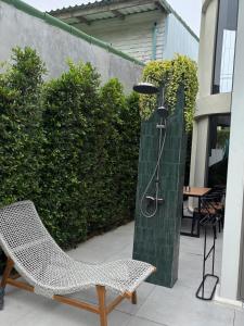a chair and a water fountain on a patio at Crown Chaloklum in Chaloklum