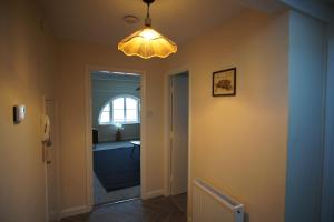 a hallway with a light hanging from a ceiling at Two Bed Flat Sea view Old town Hastings in Hastings +4 photos