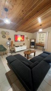 a living room with a couch and a table at Mon ti kréoline in Le Tampon