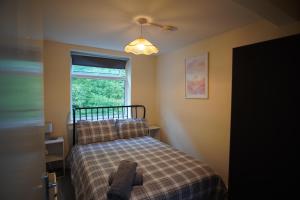 a bedroom with a bed and a window at Two Bed Flat Sea view Old town Hastings in Hastings