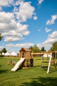 a playground with a slide and a house at Glamping pospolu in Mokrovraty