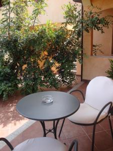 a table and chairs sitting on a patio at Relais Fenicottero Rosa in Porto San Paolo