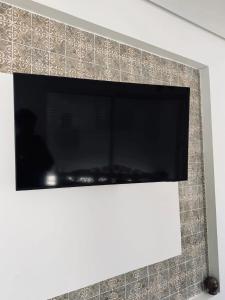 a flat screen tv hanging on a wall at La Maison de haut in Tunis