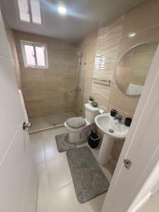 a bathroom with a toilet and a sink at The Palace in San Isidro +11 photos