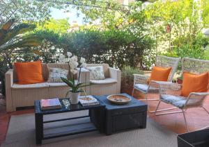 a patio with two couches and a table and chairs at Villa Serena in Viareggio