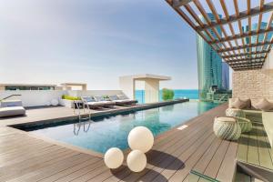 a swimming pool in the middle of a building at Charthouse Bahrain in Manama
