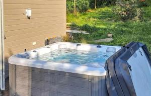 a hot tub in the backyard of a house at Beautiful Apartment In Fredrikstad in Fredrikstad