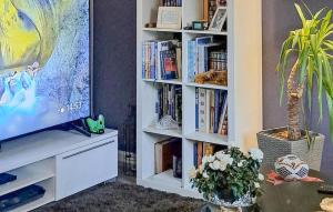 a living room with a book shelf filled with books at Beautiful Apartment In Fredrikstad in Fredrikstad