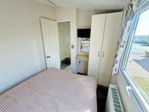 a small bedroom with a bed and a window at Europa Caernarfon - Ukc9633 in Rowen