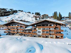 a ski lodge in the snow with snow covered ground at Haus am Anger Top 42 in Königsleiten