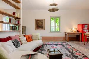 a living room with a white couch and a table at Capannacce Organic and Horse Farm in Rapolano Terme