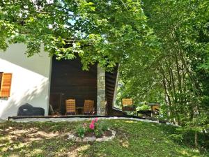 a house with a porch with chairs and trees at Ferienhaus Teichalm in Lantsch