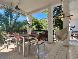 a dining room with a table and chairs on a patio at Villa Marko in Sutomore
