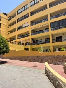 a yellow building with a walkway in front of it at 525 Aguamarina in San Miguel de Abona