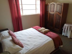 a bedroom with a bed with two towels on it at Springbok Lodge & Restaurant in Springbok