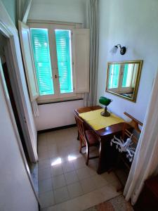 a small room with a table and a window at Albergo Regina in Senigallia