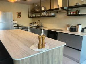 a kitchen with a counter top with bottles on it at Crown Chaloklum in Chaloklum
