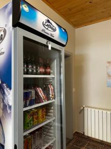 a refrigerator filled with lots of drinks at Family Nest in Shtoji i Ri