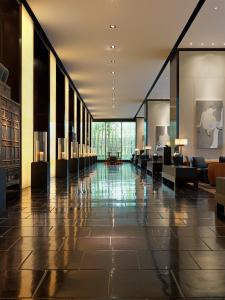 a lobby with couches and tables in a building at The Puli Hotel And Spa in Shanghai