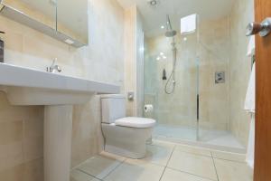 a bathroom with a toilet and a shower and a sink at The Priory Hotel in Beauly +39 photos