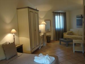 a living room with a couch and a room with a living room at Relais Fenicottero Rosa in Porto San Paolo