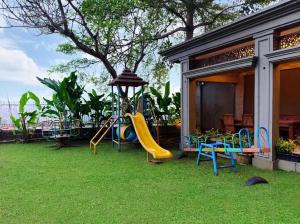 a playground with a slide in a yard at Onih Hotel in Bogor