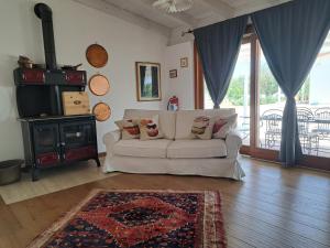 a living room with a white couch and a television at pura natura Alghero in Alghero