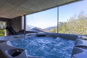 a hot tub in a room with a view at Villa moderne avec Jacuzzi - ski - golf in Icogne