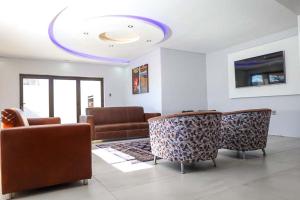 a living room with couches and a blue ceiling at Lasaro Guest Lodge in Bethlehem +21 photos