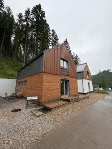 a small house is shown on the side of a road at Chata ŠENKÁRKA Zuberec in Zuberec