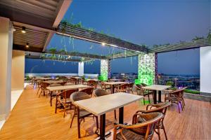 a restaurant with tables and chairs with a view at Royal Mark Hotel in Sylhet
