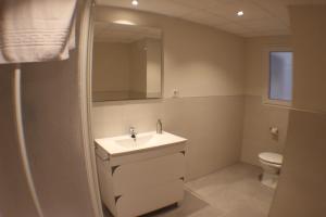 a bathroom with a sink and a toilet at Europa House Village in San Vicente del Raspeig