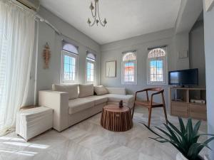 a living room with a couch and a table at Next to the Beach Apartments , Delta Hospitality in Ofrínion