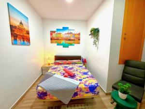 a bedroom with a bed and a chair at close to beach and 15 mints to la rambla by tren in Sant Adria de Besos
