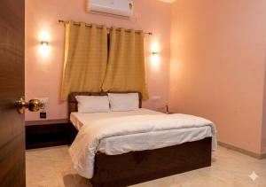 a bedroom with a large bed with a window at Raj Royal Hotel in Nagpur