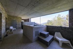 a large bathroom with a tub and a large window at Villa moderne avec Jacuzzi - ski - golf in Icogne +16 photos