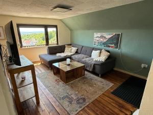 a living room with a couch and a table at Ferienhaus Weitblick in Oberthal