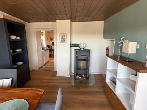 a living room with a wood burning stove in it at Ferienhaus Weitblick in Oberthal