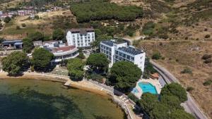 an aerial view of a hotel on a hill next to the water at Kırtay Hotel Erdek in Erdek