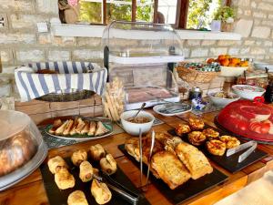 a table topped with lots of different types of food at Olympos Hotel in Platamonas +31 photos