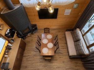 an overhead view of a living room with a table and chairs at magiy cotteg in Rozhanka Nizhnyaya