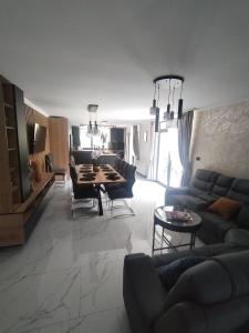 a living room with a couch and a table at Vila Cristal in Arefu
