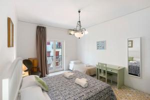 a bedroom with two beds and a table and a desk at Casa Tina in Sorrento +18 photos