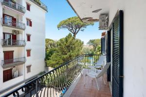 a balcony with two chairs and a tree at Casa Tina in Sorrento
