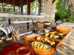 a table with plates of food on top at Olympos Hotel in Platamonas