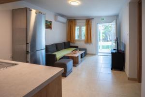 a kitchen and living room with a couch and a refrigerator at Eleonas Home Rental in Mirodháton